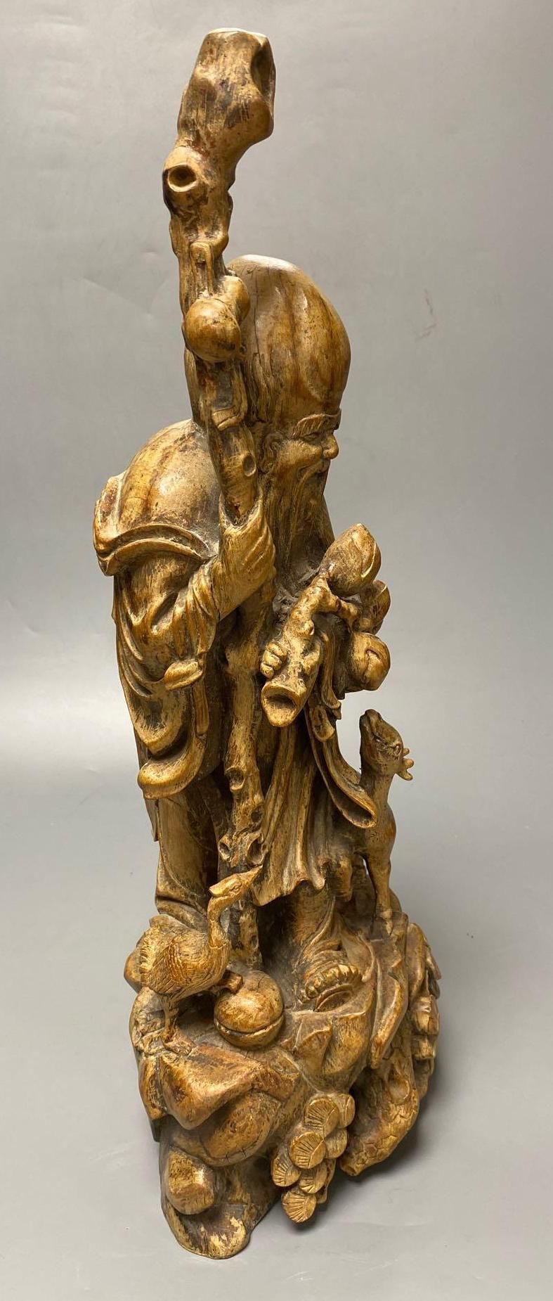 A Chinese carved hardwood figure of Shou Lao, 53cm